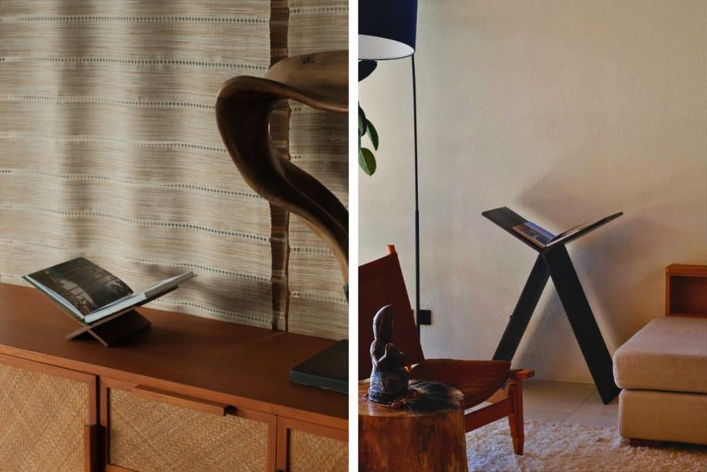 Two Stay In travel guides displayed on a wooden bookstand in a minimalist interior