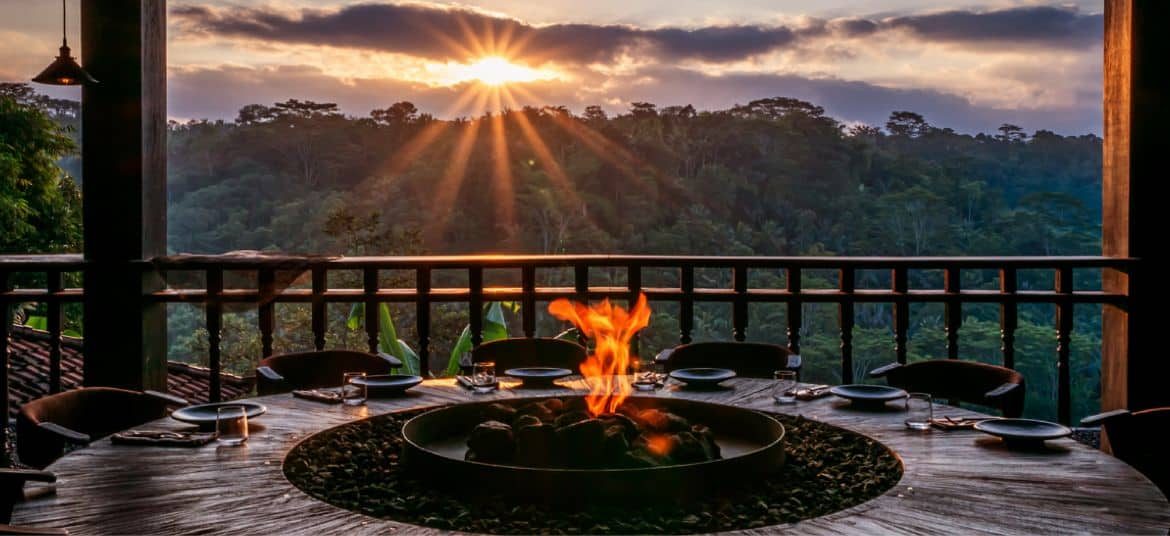 Chupacabras outdoor fire performance with guests dining under warm evening light.