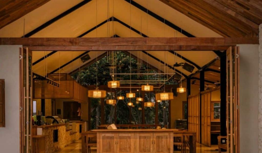 Tanah Uluwatu Indoor Dining Cozy indoor dining space at Tanah Uluwatu with modern design and warm ambiance.