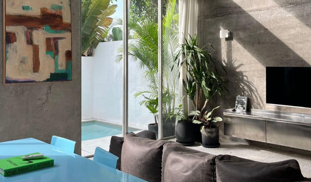 Industrial Chic Living at Sojourn Spaces Industrial living room at Sojourn Spaces with concrete walls and modern decor